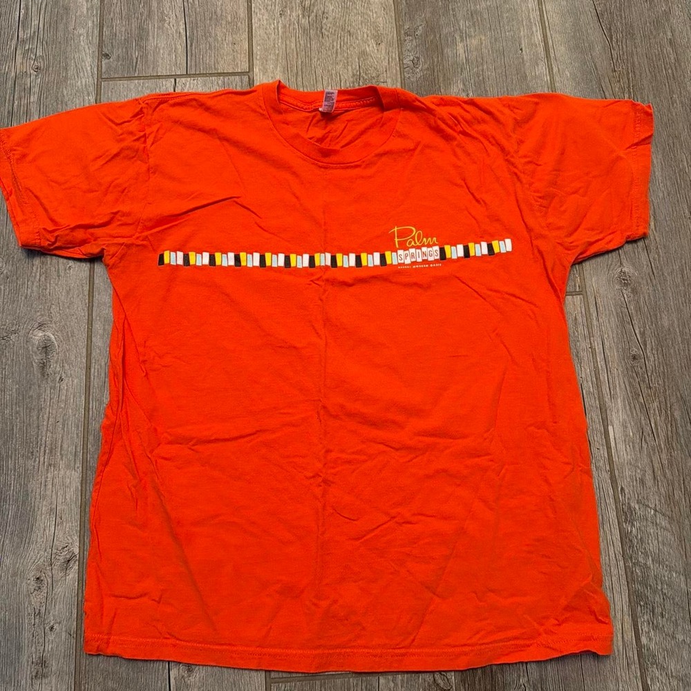 Orange Palm Springs graphic tee with horizontal stripe pattern